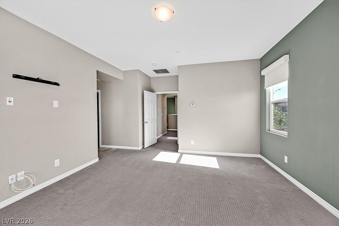 1106 Langston Ranch Avenue Henderson, NV 89002 - Photo 17 of 36 A quiet bedroom offers plush carpeting and a bright window with a pleasant outdoor view.