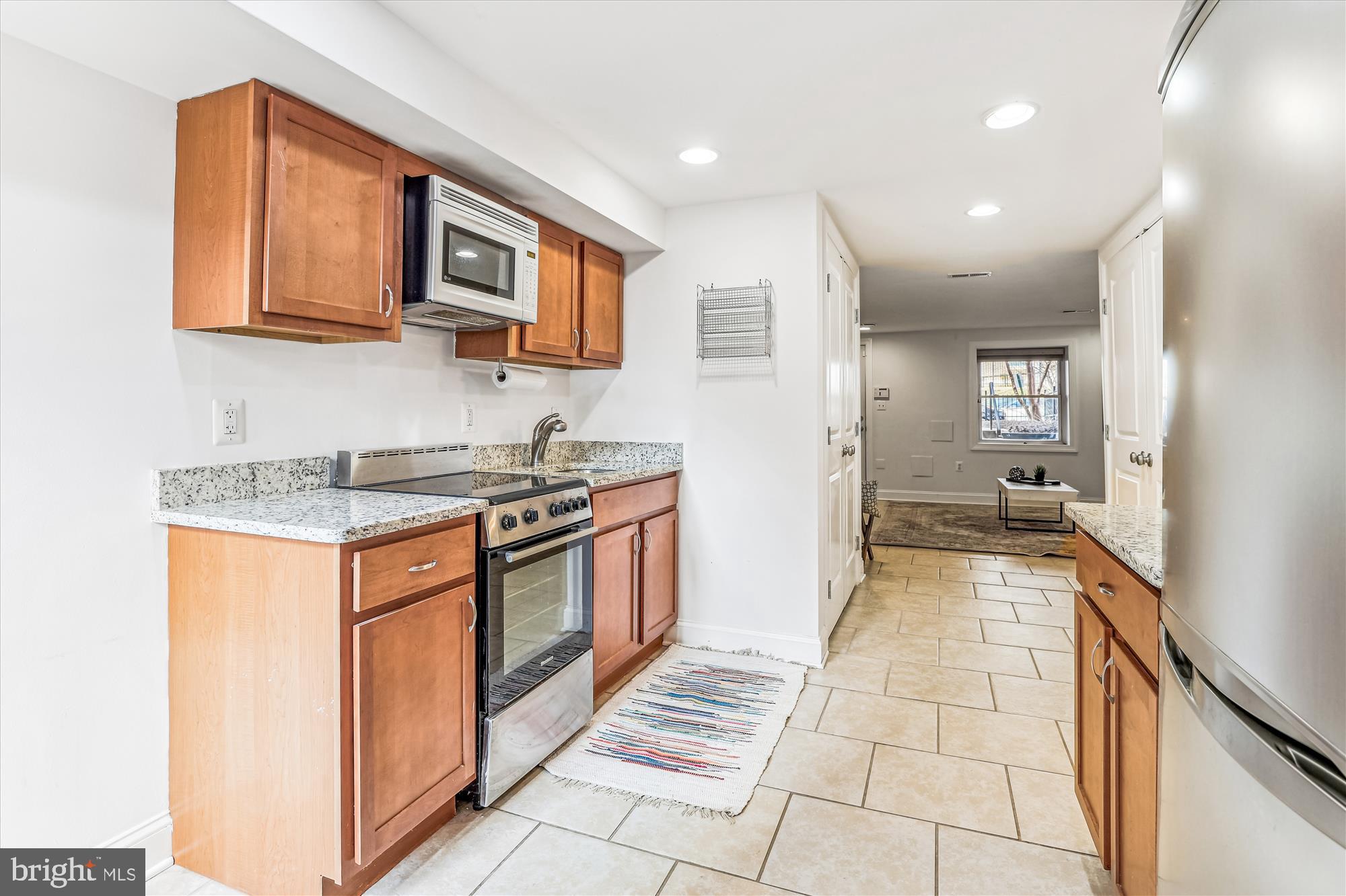 1114 Spring Road Northwest Washington, DC 20010 - Photo 46 of 142 a kitchen with stainless steel appliances granite countertop a refrigerator and a stove top oven