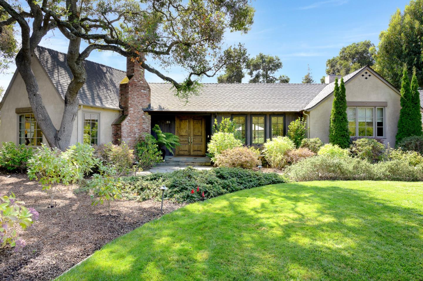 Undisclosed Address Atherton, CA 94027 - Photo 2 of 30 a front view of a house with garden