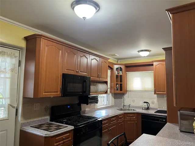 a kitchen with a sink stove top oven and microwave