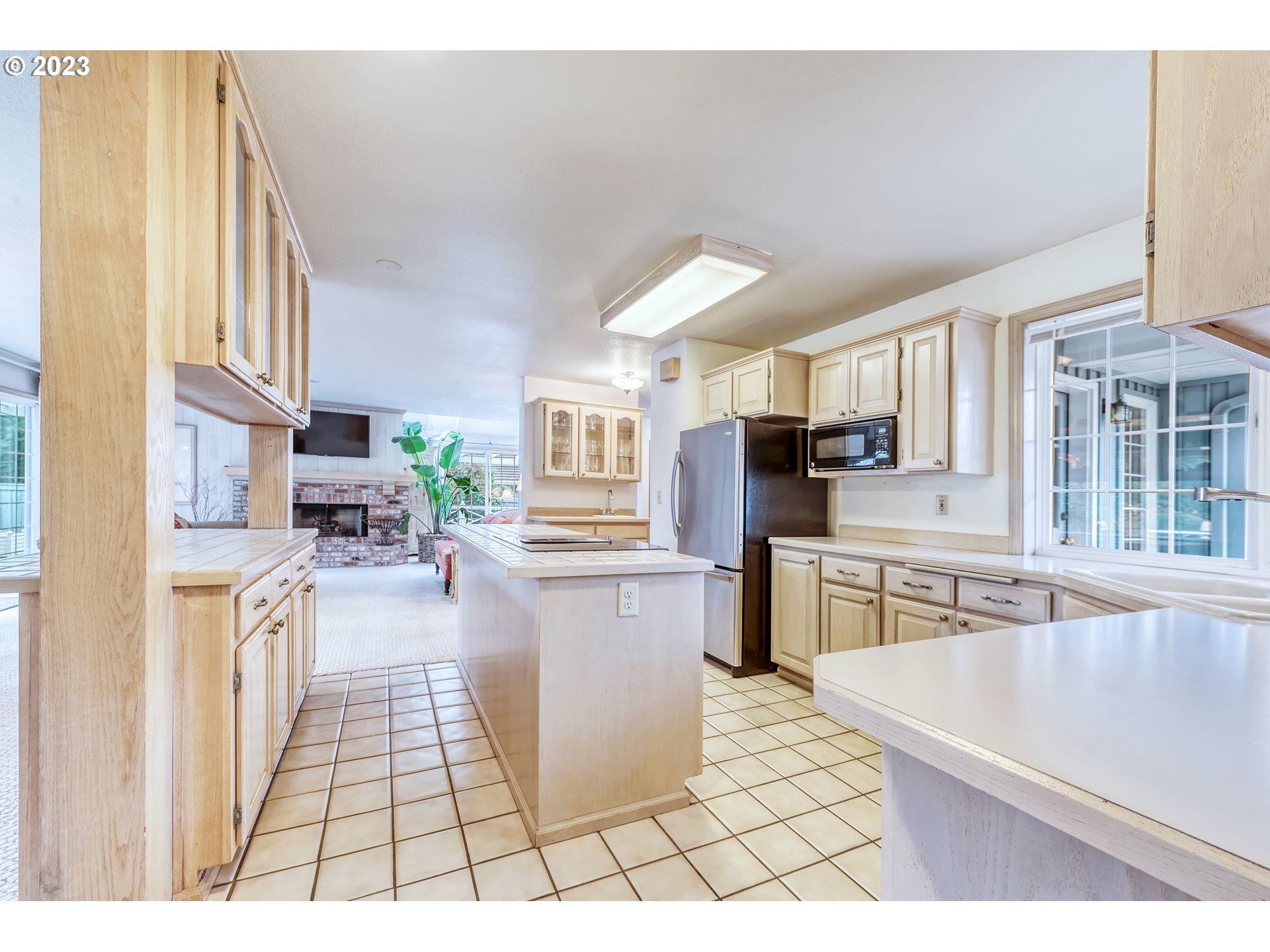 849 Fairway View Drive Eugene, OR 97401 - Photo 16 of 47 a kitchen with stainless steel appliances kitchen island granite countertop a refrigerator a stove a sink dishwasher and white cabinets with wooden floor