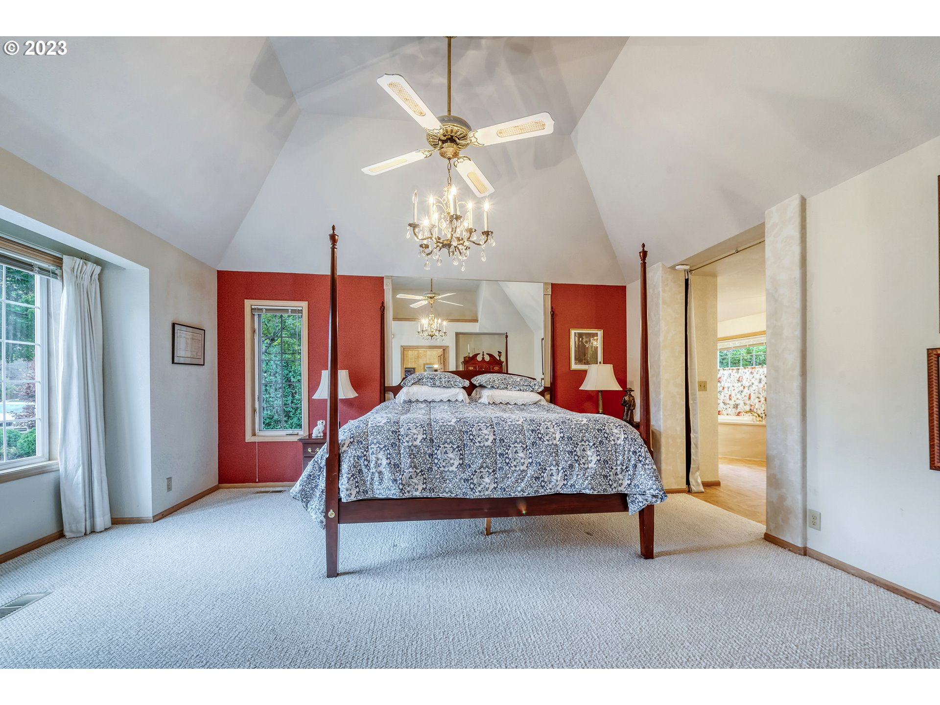849 Fairway View Drive Eugene, OR 97401 - Photo 23 of 47 a bedroom with a large bed chandelier and a window