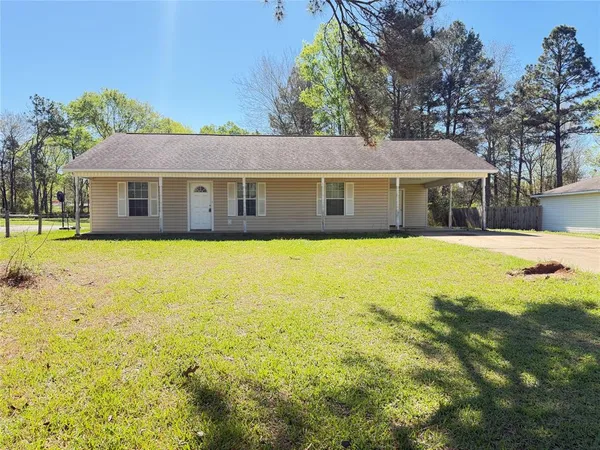 a view of house with a yard