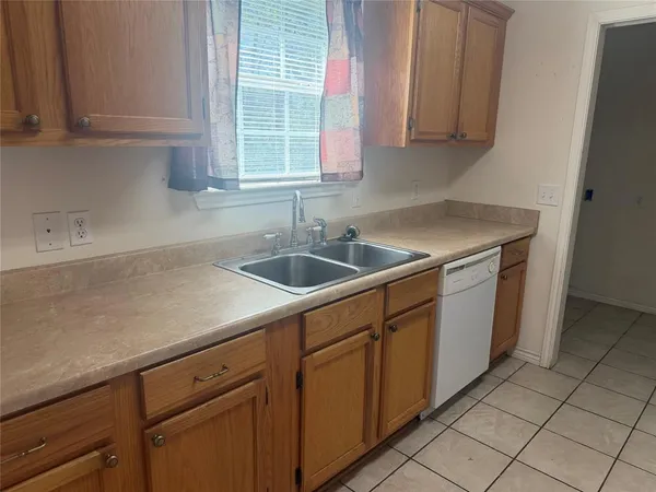 a kitchen with a sink and cabinets