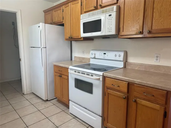 a kitchen with stainless steel appliances granite countertop cabinets and a refrigerator
