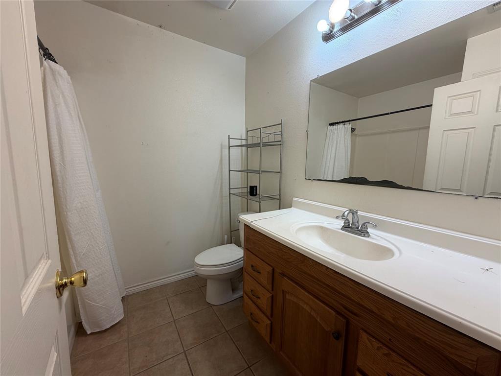 2502 Davisville Road Lufkin, TX 75901 - Photo 16 of 30 a bathroom with a sink toilet and mirror