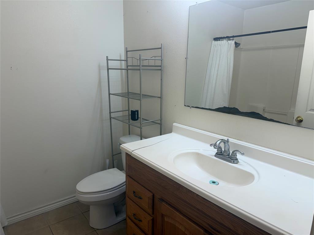 2502 Davisville Road Lufkin, TX 75901 - Photo 17 of 30 a bathroom with a sink toilet and vanity