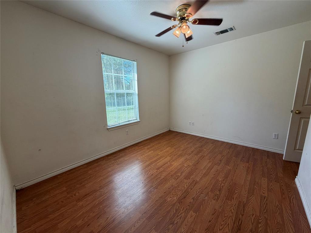 2502 Davisville Road Lufkin, TX 75901 - Photo 19 of 30 a view of empty room with wooden floor and fan
