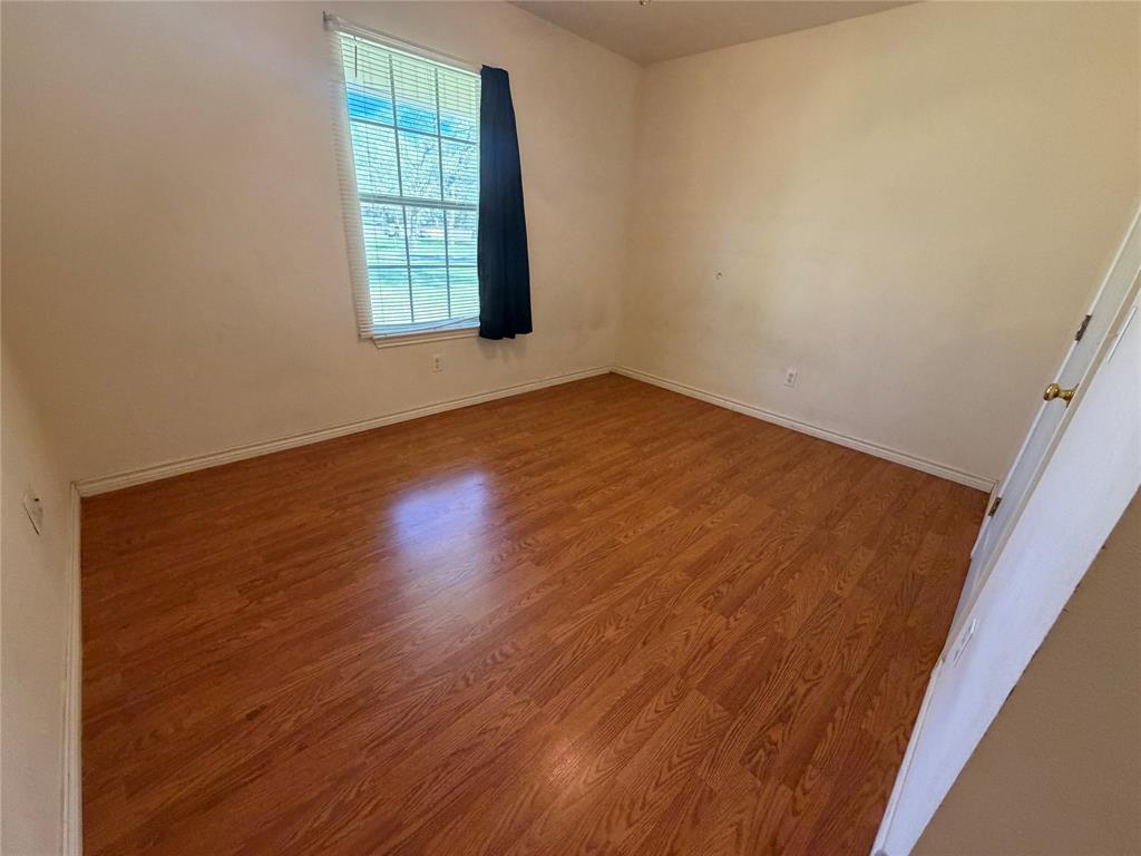 2502 Davisville Road Lufkin, TX 75901 - Photo 24 of 30 an empty room with wooden floor and windows