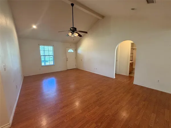 a view of a room with window and wooden floor