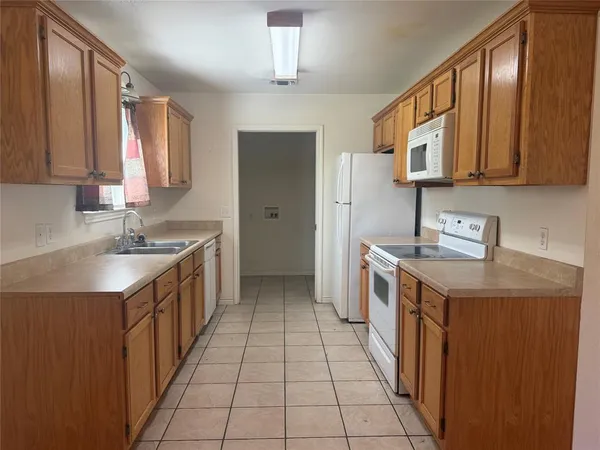 a kitchen with a stove top oven sink and cabinets