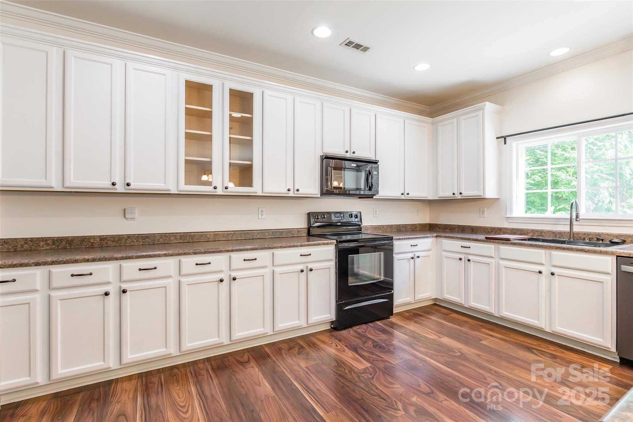 9312 Seamill Road Charlotte, NC 28278 - Photo 12 of 30 a kitchen with granite countertop white cabinets white appliances and sink