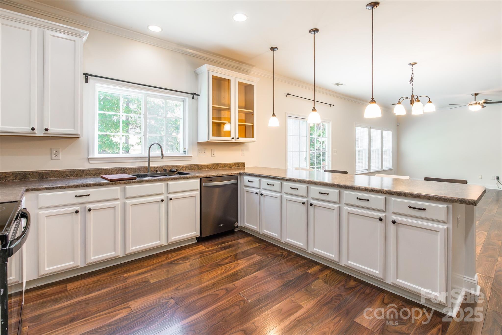 9312 Seamill Road Charlotte, NC 28278 - Photo 13 of 30 a kitchen with stainless steel appliances granite countertop a sink a window and white cabinets