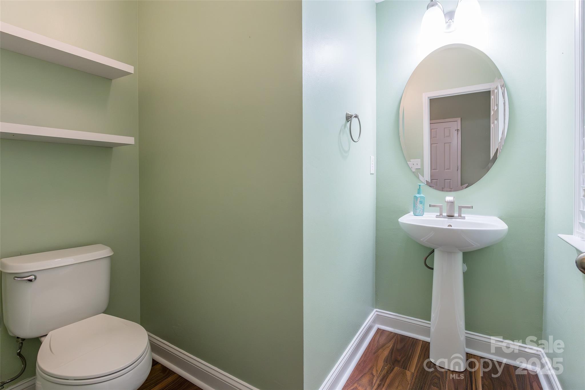 9312 Seamill Road Charlotte, NC 28278 - Photo 15 of 30 a bathroom with a toilet sink and mirror