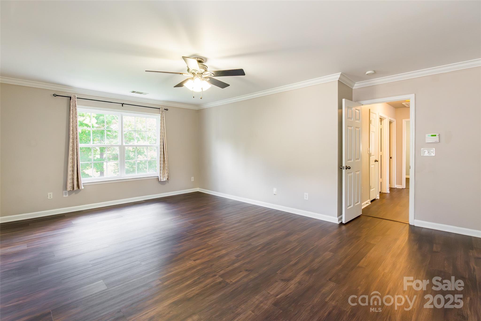 9312 Seamill Road Charlotte, NC 28278 - Photo 17 of 30 a view of an empty room with wooden floor and a window