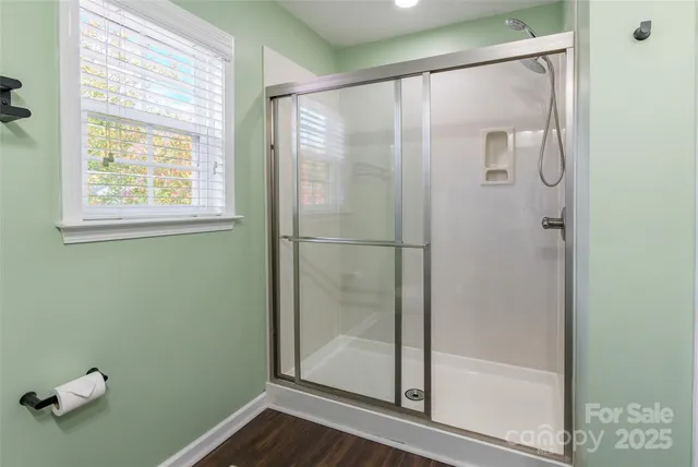 a bathroom with a glass shower door