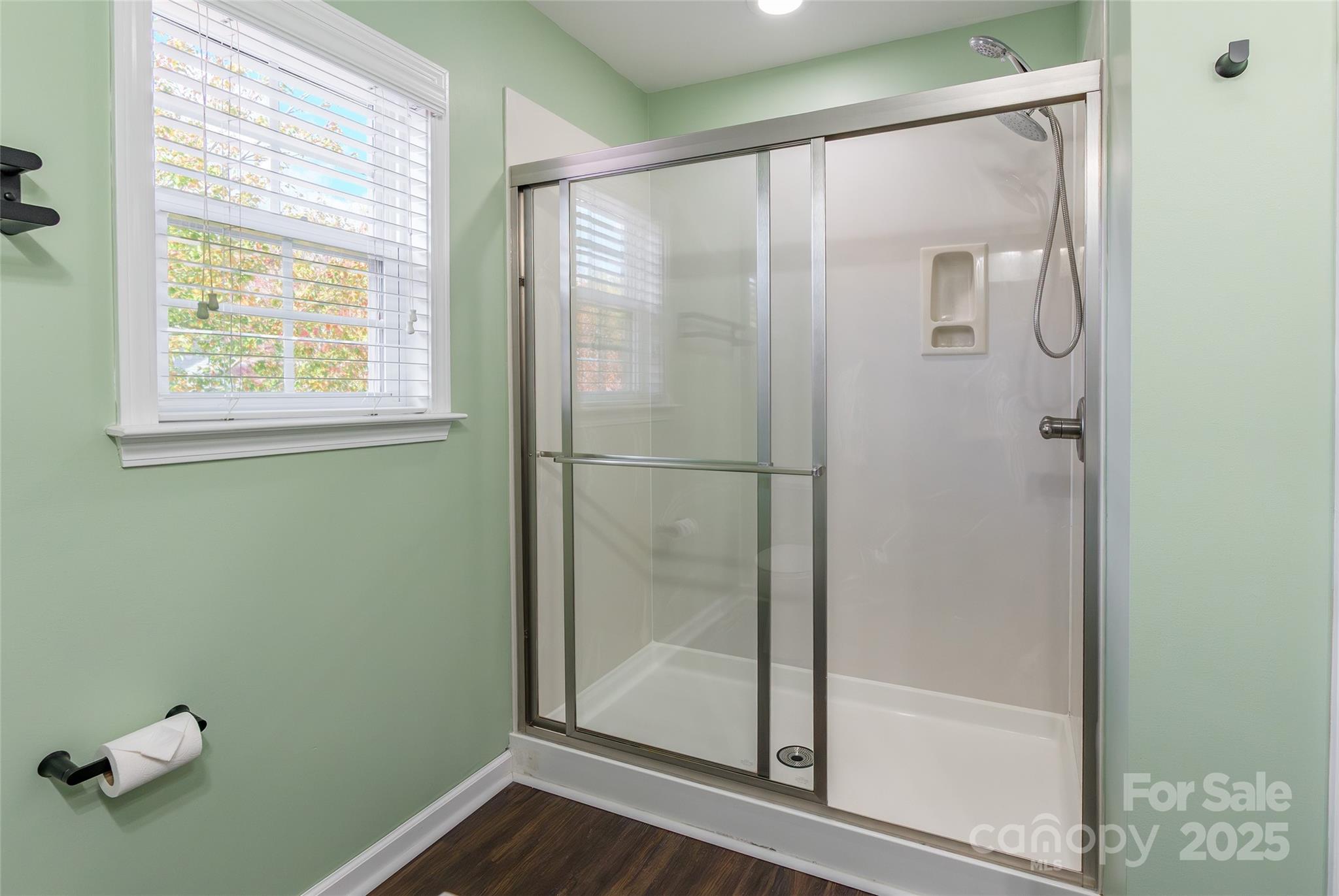 9312 Seamill Road Charlotte, NC 28278 - Photo 20 of 30 a bathroom with a glass shower door