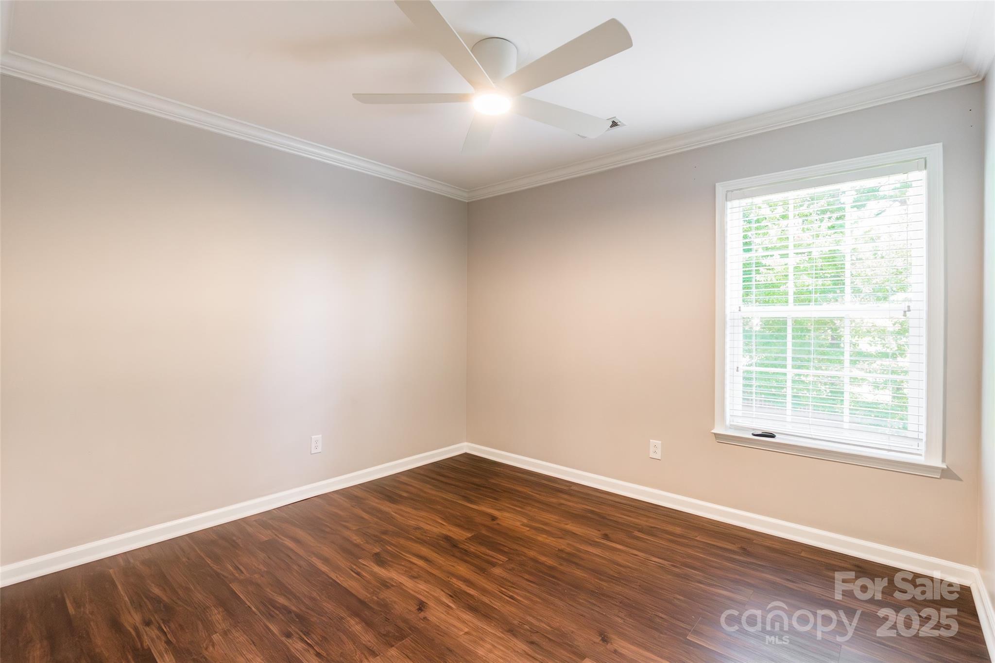 9312 Seamill Road Charlotte, NC 28278 - Photo 21 of 30 an empty room with wooden floor and windows