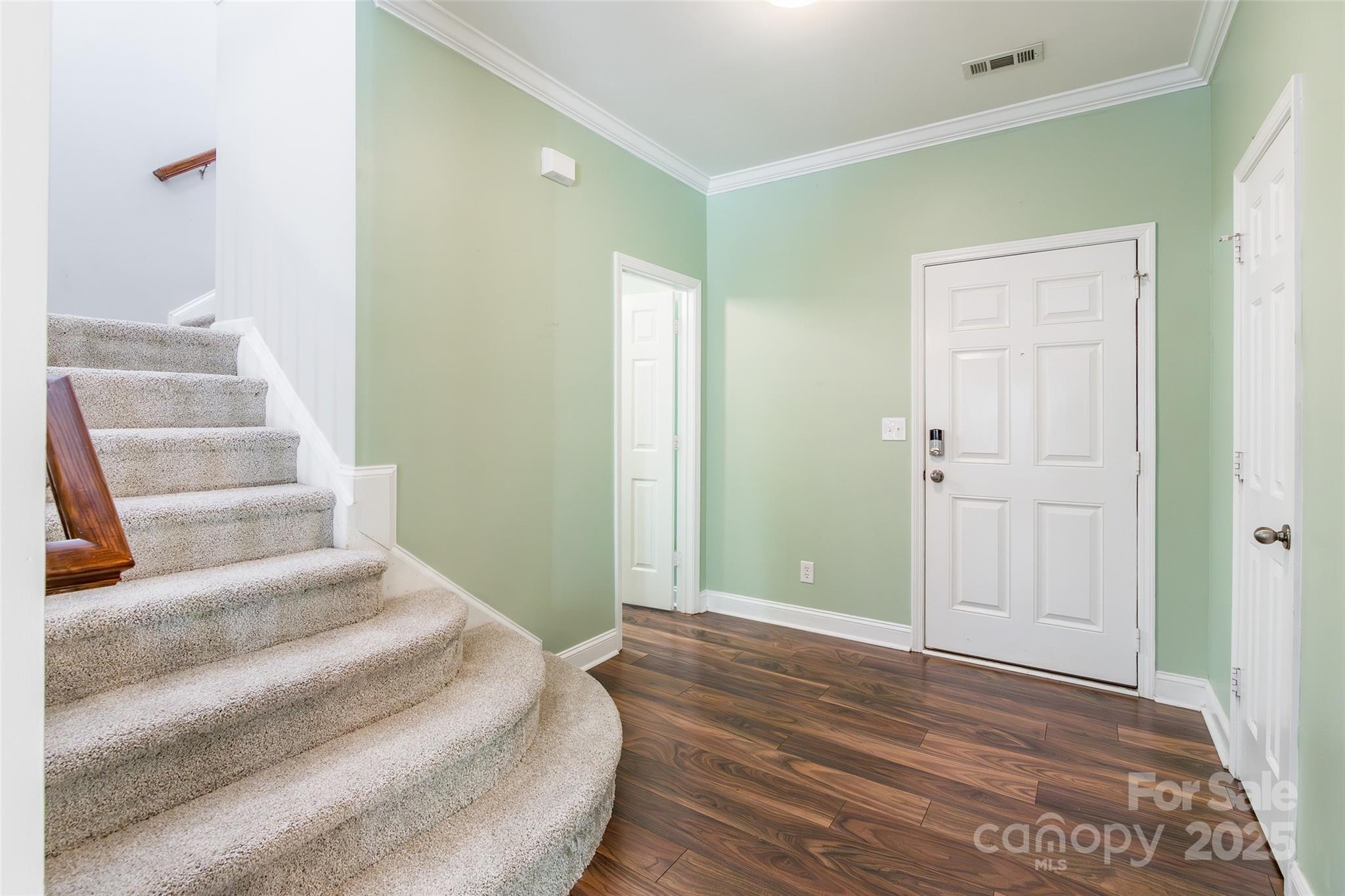 9312 Seamill Road Charlotte, NC 28278 - Photo 5 of 30 a view of a bedroom with wooden floor and white walls