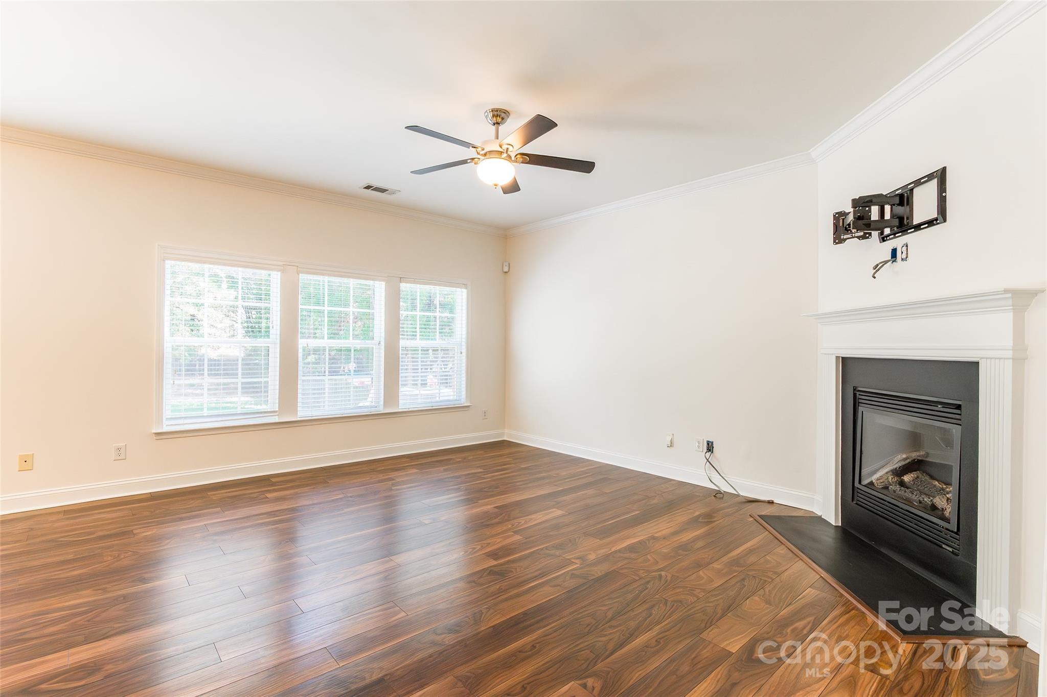 9312 Seamill Road Charlotte, NC 28278 - Photo 6 of 30 a view of an empty room with a fireplace and a window