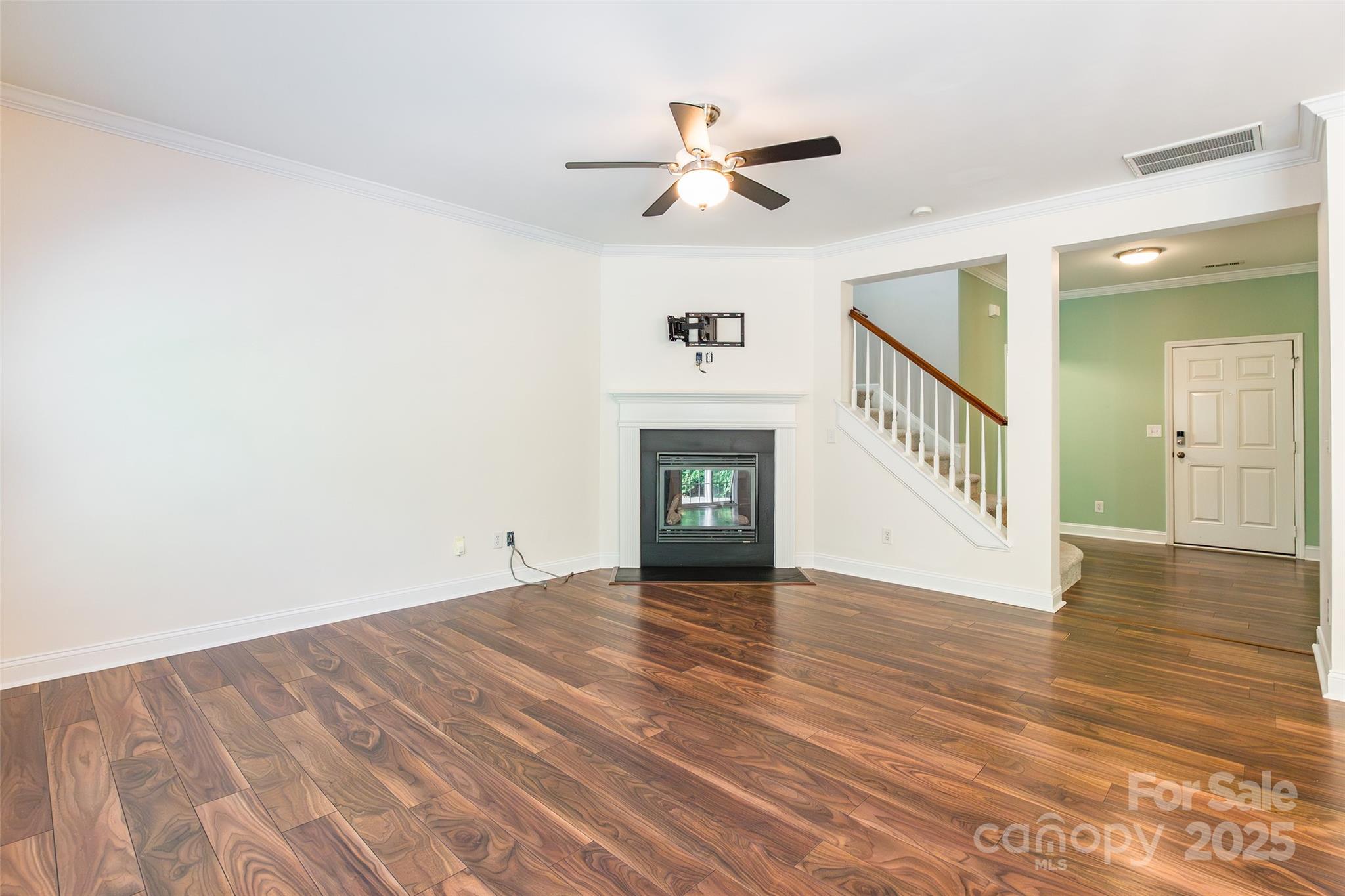 9312 Seamill Road Charlotte, NC 28278 - Photo 8 of 30 a view of an empty room with wooden floor and a fireplace