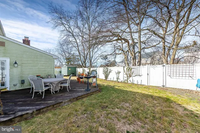 a view of a backyard with table and chairs