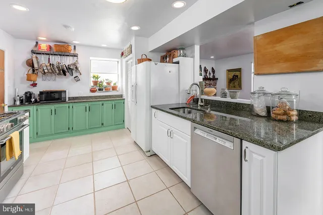 a kitchen with granite countertop a sink and cabinets