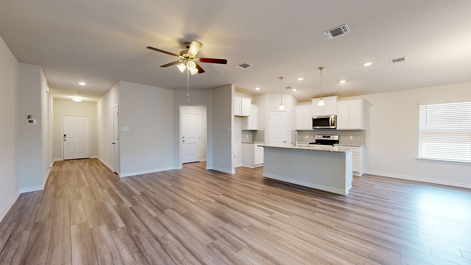 238 Water Wl Road Burnet, TX 78611 - Photo 32 of 33 Kitchen with open floor plan, white cabinetry, a ceiling fan, and hanging light fixtures