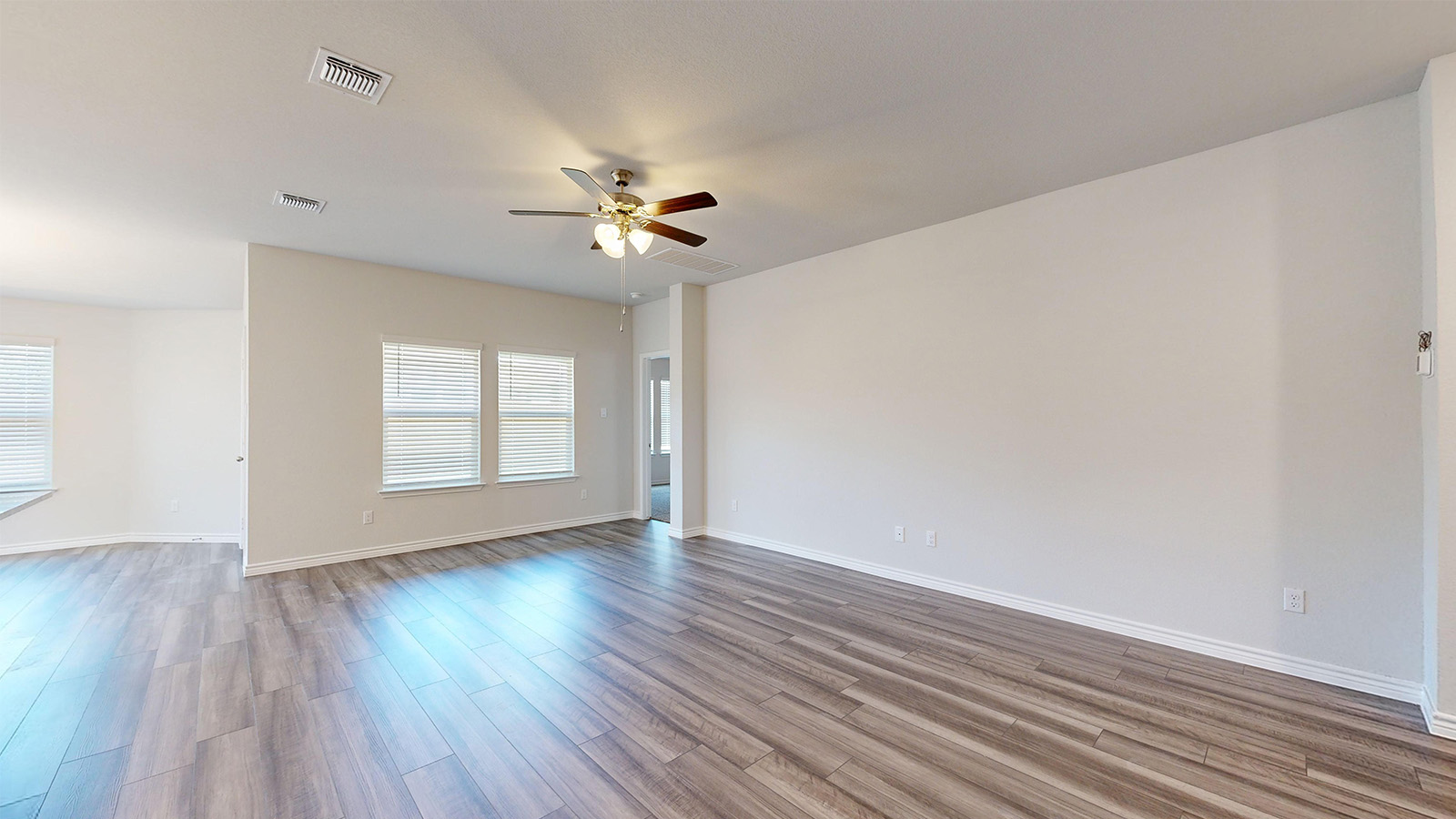 238 Water Wl Road Burnet, TX 78611 - Photo 9 of 33 Unfurnished room with a ceiling fan and wood finished floors