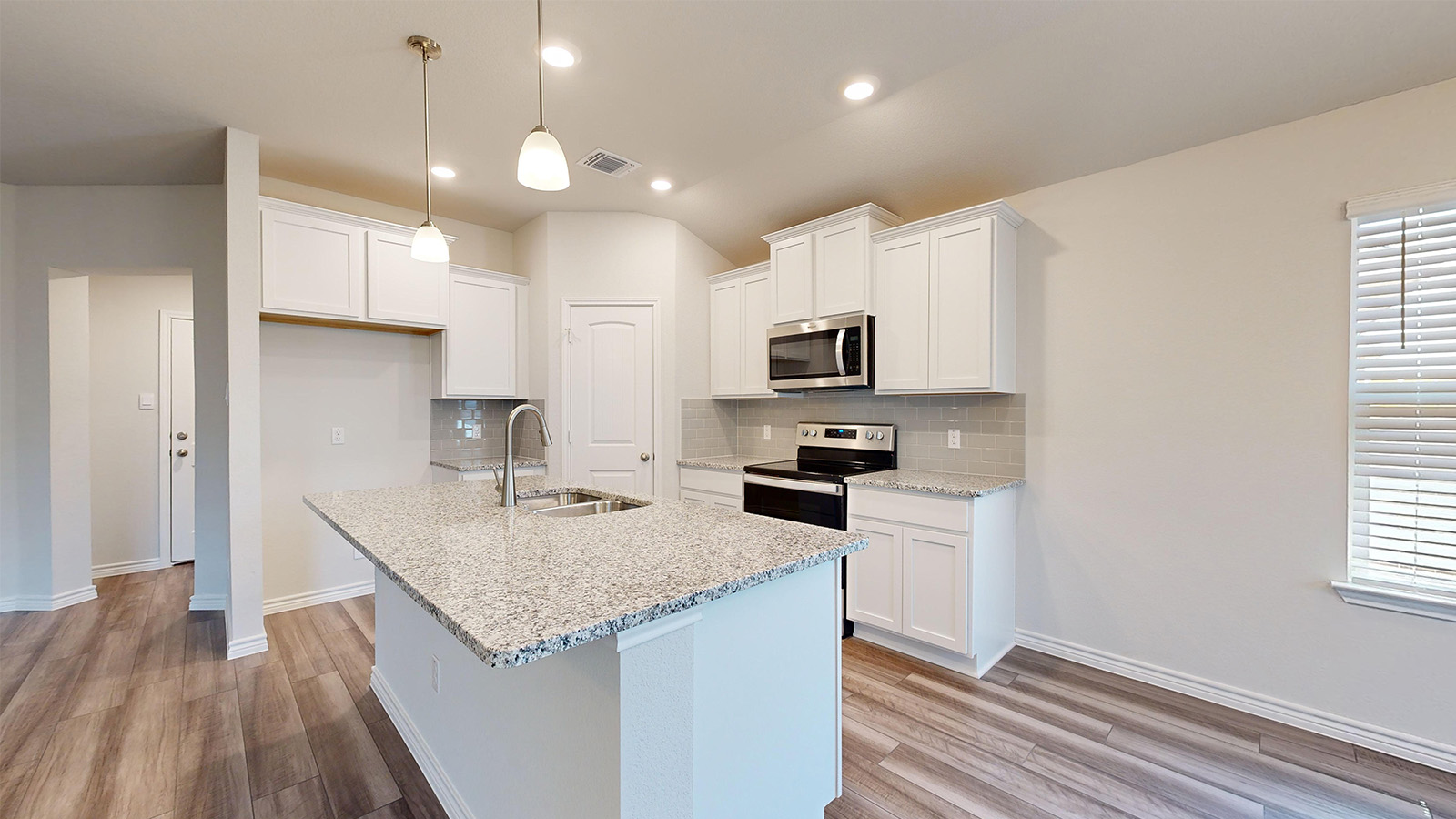 238 Water Wl Road Burnet, TX 78611 - Photo 3 of 33 Kitchen featuring white cabinets, light stone counters, light wood-type flooring, and decorative backsplash