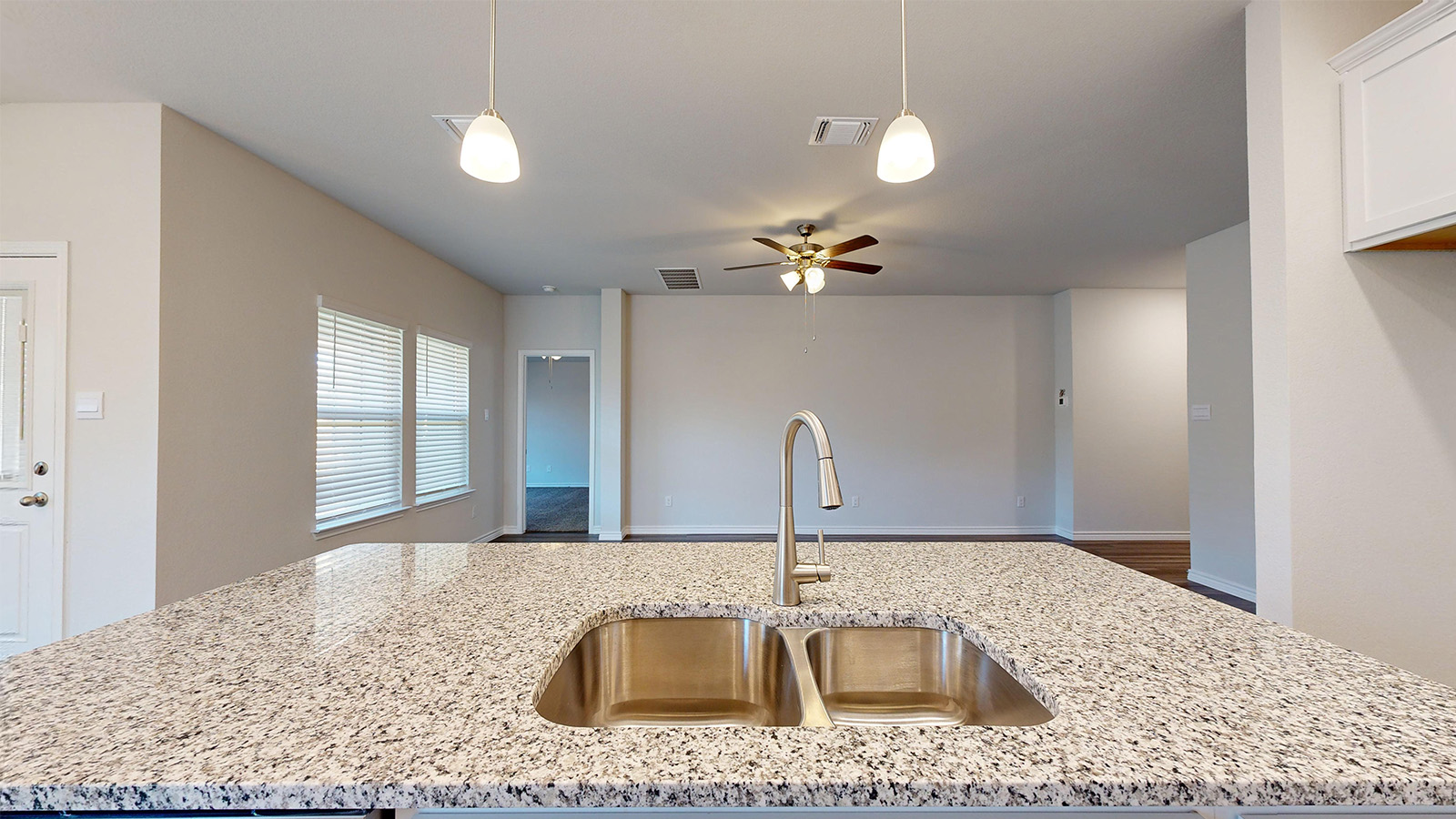 238 Water Wl Road Burnet, TX 78611 - Photo 29 of 33 Kitchen with decorative light fixtures, light stone countertops, ceiling fan, an island with sink, and open floor plan