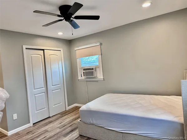 a kitchen with stainless steel appliances granite countertop a stove top oven a sink dishwasher a refrigerator and cabinets with wooden floor