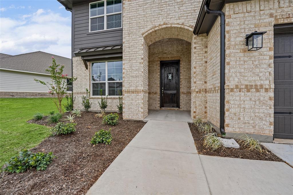 1205 Colca Drive Springtown, TX 76082 - Photo 5 of 37 Light-toned brick exterior with dark horizontal siding