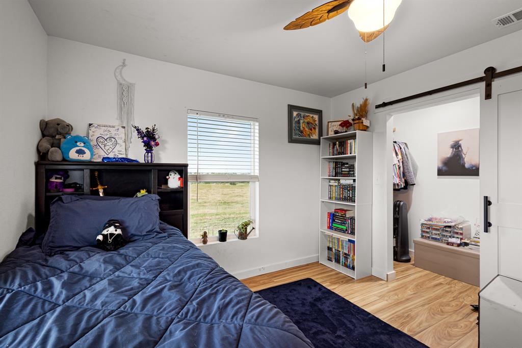 124 County Road 4511 Decatur, TX 76234 - Photo 25 of 39 a bedroom with a bed and a book shelf