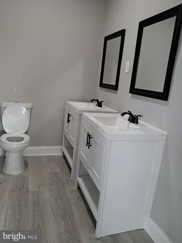 an empty room with a fireplace and windows