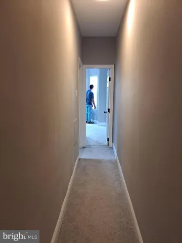 a view of a small space with wooden floor and a window