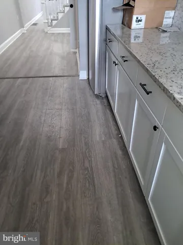 a kitchen with stainless steel appliances granite countertop a sink refrigerator and microwave