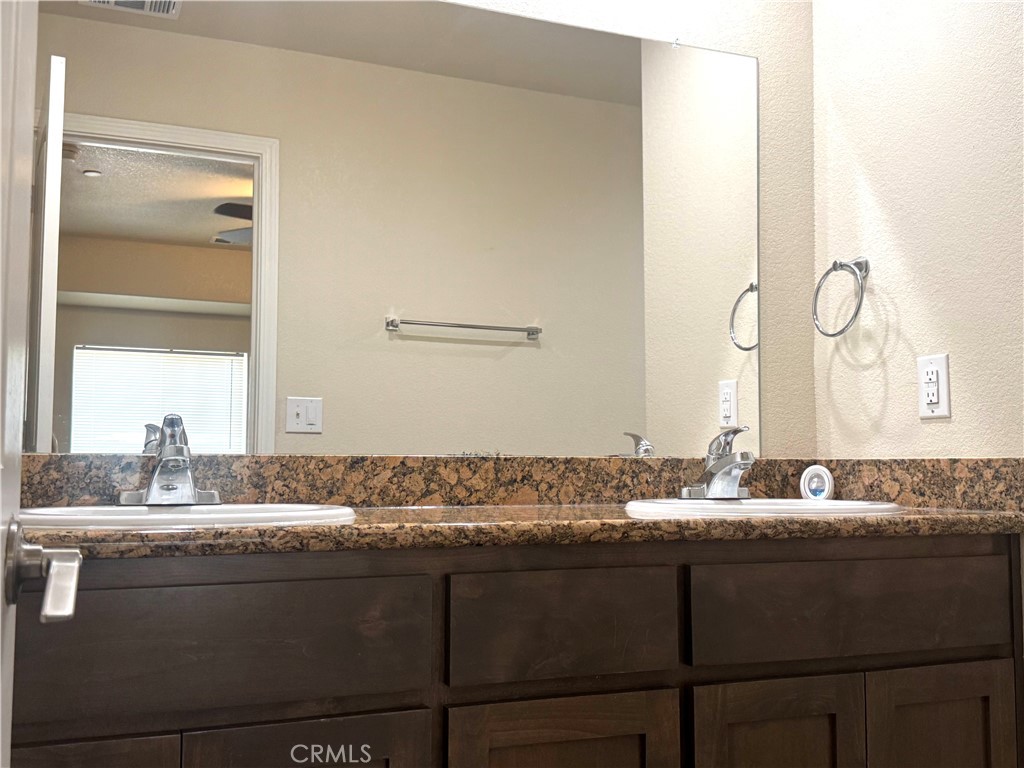 1339 Playa Del Rey Drive Merced, CA 95348 - Photo 26 of 48 a bathroom with a granite countertop sink and a mirror