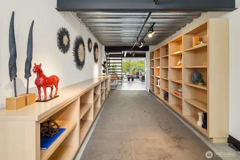 a bedroom with a bed a window and potted plant