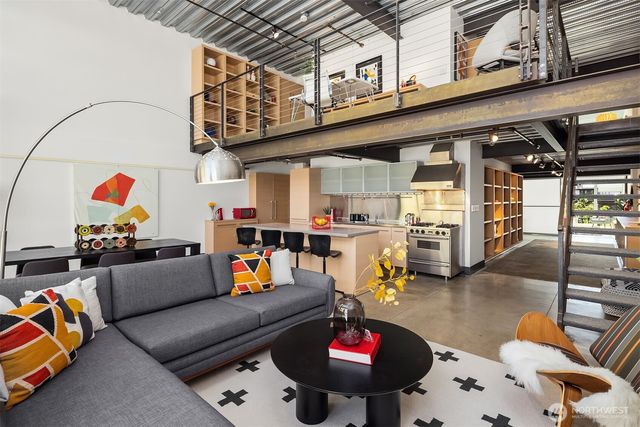 a living room with furniture and a floor to ceiling window