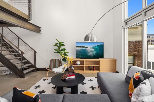 a living room with furniture and a potted plant