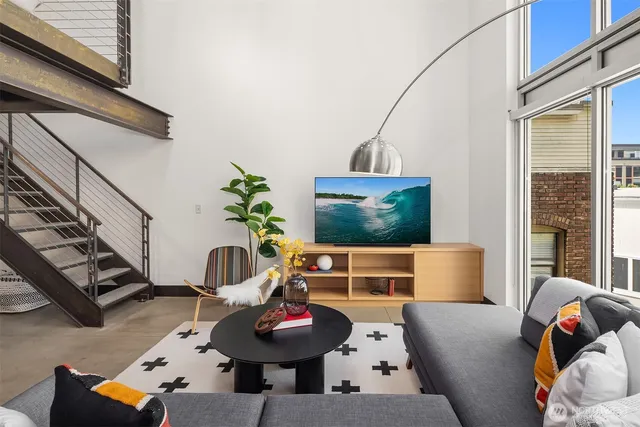 a living room with furniture and a potted plant