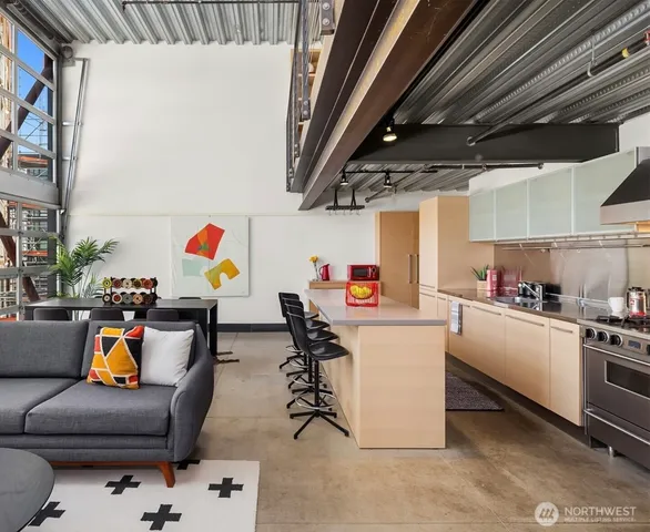 a living room with furniture and a kitchen view