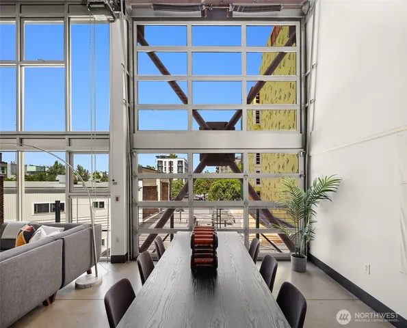 a dining room with furniture and a floor to ceiling window