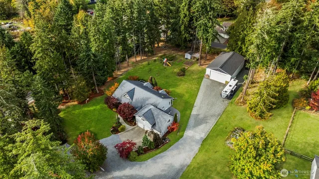 an aerial view of a house with a yard basket ball court and outdoor seating