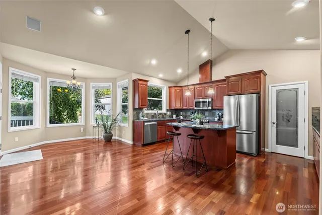 a spacious bathroom with a double vanity sink large mirror and a bathtub