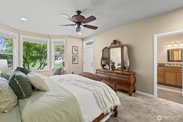 a view of a house with a barbeque and wooden bench