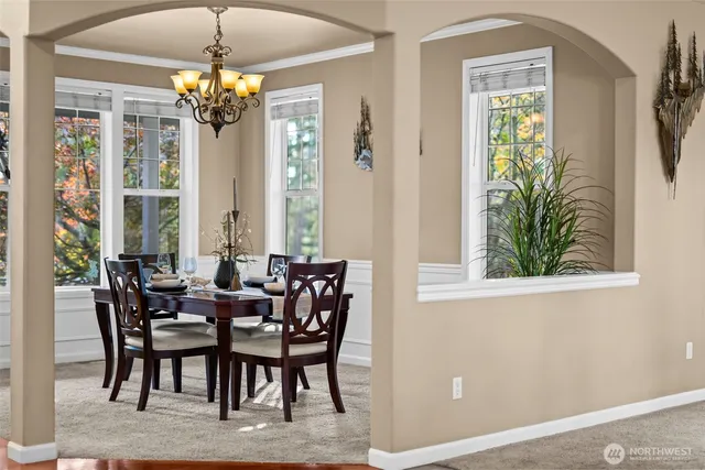 a living room with furniture chandelier and a fireplace