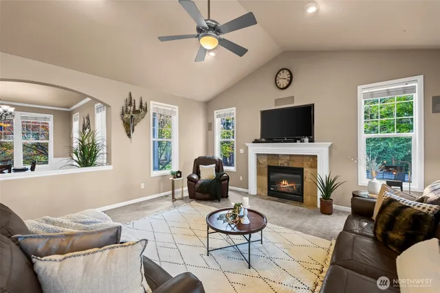 a open kitchen with stainless steel appliances granite countertop a refrigerator a sink dishwasher a stove and a dining table with wooden floor