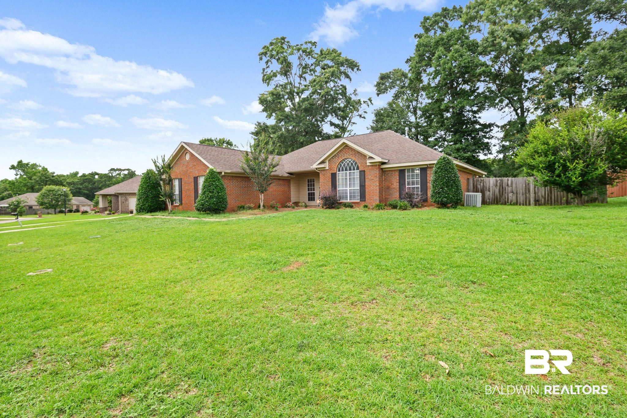 9422 Labrador Run South Mobile, AL 36695 - Photo 3 of 36 Brick exterior with a shingle roof and green landscaping